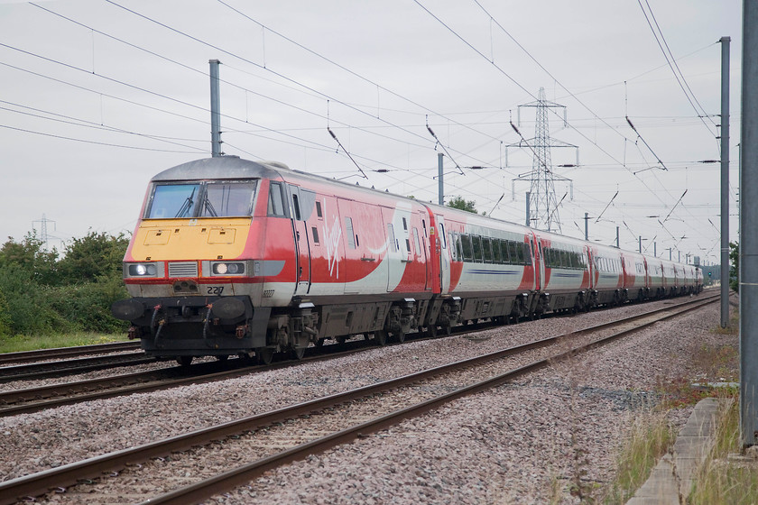 82227, GR 06.55 Skipton-London Kings Cross (1A13, 1E), Tempsford Crossing 
 DVT 82227 leads the 06.55 Skipton to King's Cross past Tempsford between St. Neots and Sandy. This picture clearly illustrates the problems of photographing under the wires. The DVT has an electrification mast growing out of its roof! The aim is always to try and get the subject between masts, something that did not happen here. 
 Keywords: 82227 1A13 Tempsford Crossing