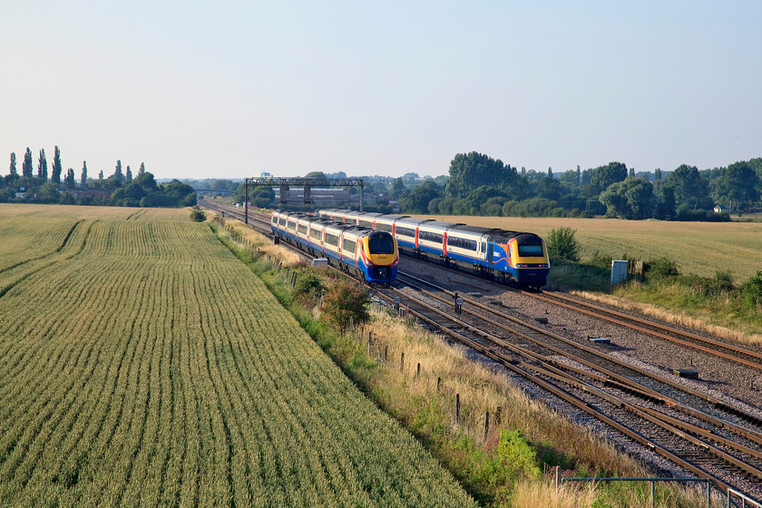 222006, EM 17.57 London St. Pancras-Sheffield (1F60, 2L) & 43073 & 43066, EM 17.45 London St. Pancras-Derby (1D090, 2L), Harrowden Junction 
 The race is on! 222006 'The Carbon Cutter' accelerates away from Harrowden Junction with the 17.57 St. Pancras to Sheffield. This train will run non-stop through to its next stop at Leicester. Meanwhile, 43066 brings up the rear of the 17.45 St. Pancras to Derby, that is on the relief line ready for its next stop at Kettering some five miles to the north. 
 Keywords: 222006 1F60 43073 43066 1D090 Harrowden Junction