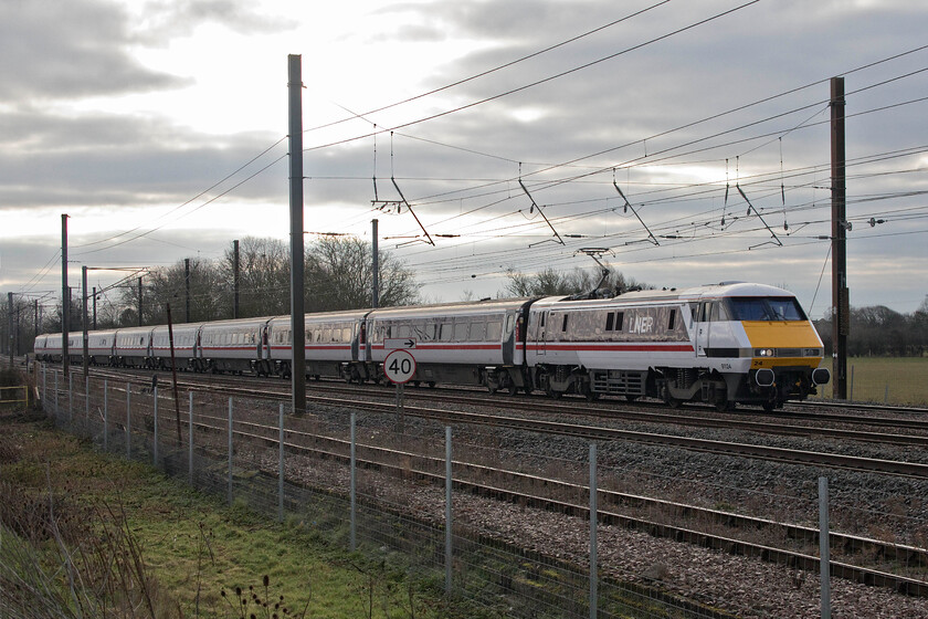 91124, 08.33 London King's Cross-Leeds (1D06, RT), Tallington Dowmac 
 The old order is still in operation on the ECML. In what was arguably the pinnacle of design and build by British Rail a few of the Mk. IV IC225 sets are still in frontline operation, still providing passengers with a great travelling experience. 91124 leads the 08.33 King's Cross to Leeds service past Tallington taken from the Dowmac concrete plant embankment just north of the infamous level crossing. 
 Keywords: 91124 08.33 London King's Cross-Leeds 1D06 Tallington Dowmac IC225InterCity Swallow LNER