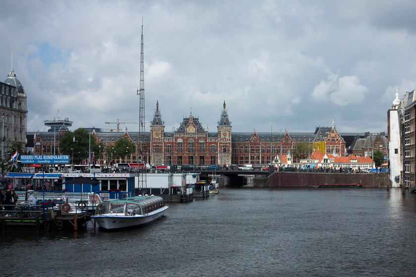 Frontage, Amsterdam Central station 
 Amsterdam Central is a very impressive structure built in the Gothic Renaissance Revival style and opened in 1889. Like much of The Netherlands, it is built on reclaimed land that caused huge problems during construction. The architect was Pierre Cuypers who was also responsible for other buildings such as the Rijksmuseum with which is shares many similarities. Despite it being in the capital city, it is the second busiest Dutch station beaten to place by Utrecht Central. 
 Keywords: Frontage Amsterdam Central station