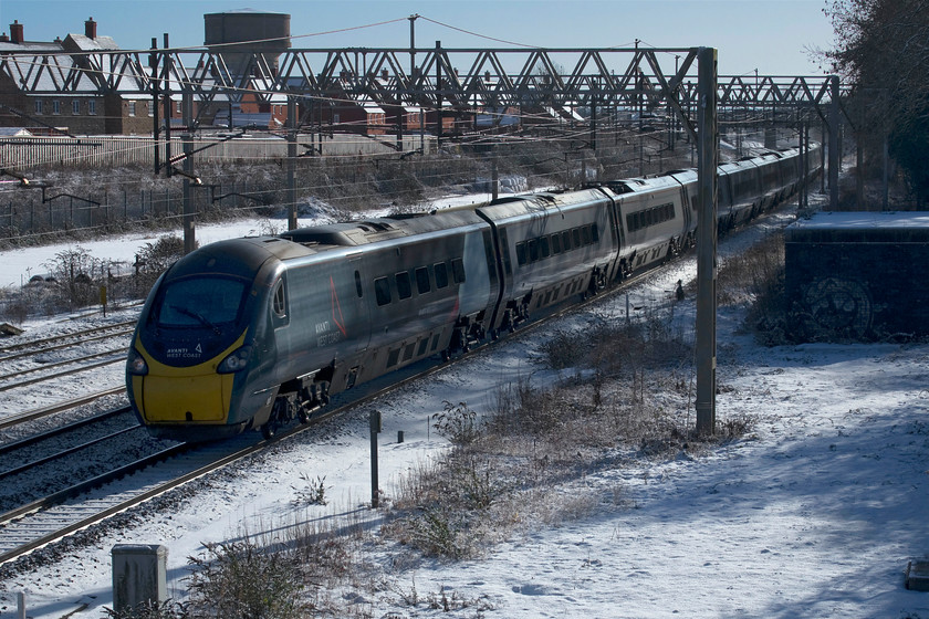 390130, VT 10.20 London Euston-Manchester Piccadilly (1H18, 27L), site of Roade station 
 390130 'City of Edinburgh' passes the site of Roade's former station working the 10.20 Euston to Manchester Piccadilly. Like many services on the WCML today there were delays further north with this particular service held near to Colwich Junction making it nearly half an hour adrift on arrival at Piccadilly station. This was my final picture of the morning and, with cold feet and fingers, it was time to head home for a cup of tea! 
 Keywords: 390130 10.20 London Euston-Manchester Piccadilly 1H18 site of Roade station Avanti West Coast Pendolino City of Edinburgh