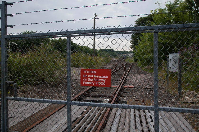 Entrance to Micheldever oil depot 
 The rail access to Micheldever oil depot where it intersects with the station access path from the east. The large oil depot was built in 1939 as part the war effort. It remained in use until the early 1990s but has since seen little use. It is evident that recent clearance has taken place and that a planning application was put in to develop the site but this was refused. 
 Keywords: Micheldever oil depot