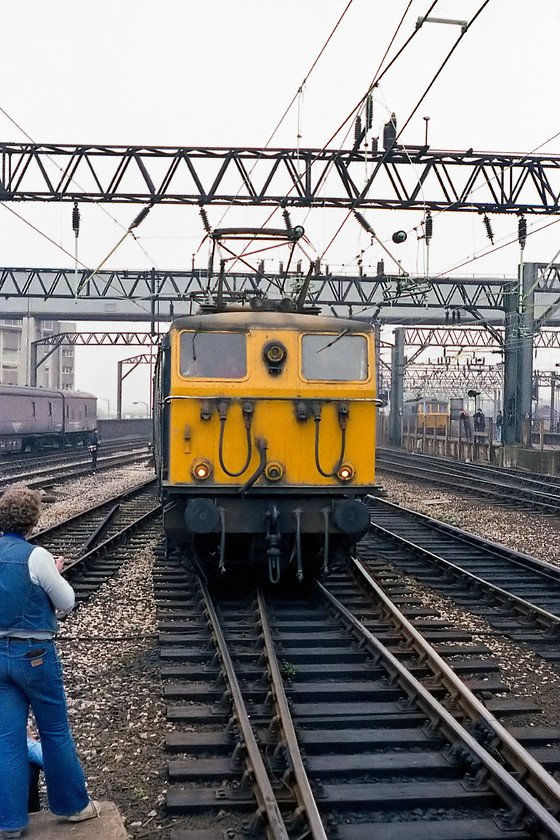 76009, joining the Pennine Explorer, Cardiff Central-Rotherwood, Manchester Piccadilly station 
 On the end of Manchester Piccadilly's platform one, 76009 comes slowly into the station to attach to the Pennine Exporerer railtour. With 76014 it would haul the railtour over the doomed Woodhead route all the way to Rotherwood Exchange sidings to the east of Sheffield. Notice the tolerance endowed upon us spotters by being permitted right down to track level on the platform ramps. Also notice in the background a class 86. My notes have this down as possibly being current day celebrity 86259. There must be hundreds of photographs and notes out there, can anybody possibly confirm this? 
 Keywords: 76009 Pennine Explorer Cardiff Central-Rotherwood Manchester Piccadilly station