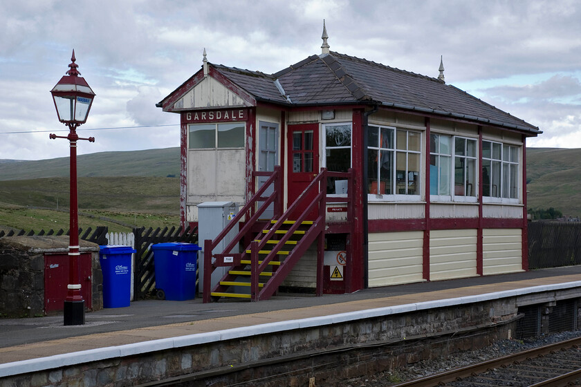 Garsdale signal box & station (Mid, 1908) 
 A second view of Garsdale signal box situated on the down platform of the station of the same name. This is a wild spot high up in the Yorkshire Dales at the head of Garsdale itself that stretches all the way from Sedbergh close to the M6 near to Kendal. On a summer's day such as this, despite it being dull and overcast it must be a benign place to be a signalman but on a wild and stormy night in January, it must be a very different proposition! 
 Keywords: Garsdale signal box station 1908 Midland Railway