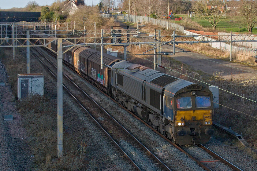 66304, 14.40 DIRFT-Dollands Moor (6O55, 4L), site of Roade station 
 Beacon Rail does not appear to be taking much care of their locomotives (externally at least) judging by the appearance of 66304 as seen here! Operated by GBRf the filthy locomotive is seen leading the 6O55 daily 14.40 (or thereabouts) 14.40 Daventry (DIRFT) to Dollands Moor empty water train through Roade just managing to capture a little afternoon winter sunshine. 
 Keywords: 66304 14.40 DIRFT-Dollands Moor 6O55 site of Roade station