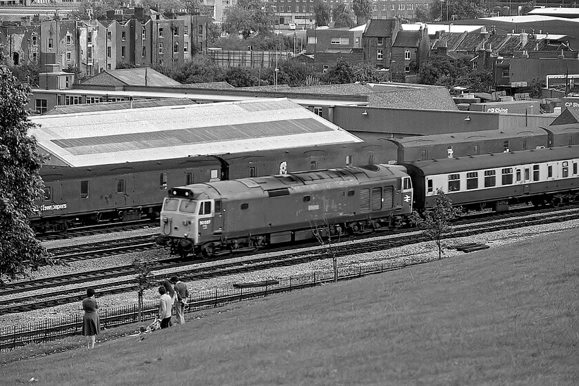 50037, unidentified down working, Victoria Park 
 Unfortunately, this photograph of 50037 'Illustrious' leaving Bristol taken from Victoria Park is a little out of focus. However, I have very few images taken from this popular spot so I have included it. The newspaper vans in the background are stabled in the Malogo Vale sidings that extended as far as Bedminster station. 
 Keywords: 50037 unidentified down working Victoria Park Illustrious