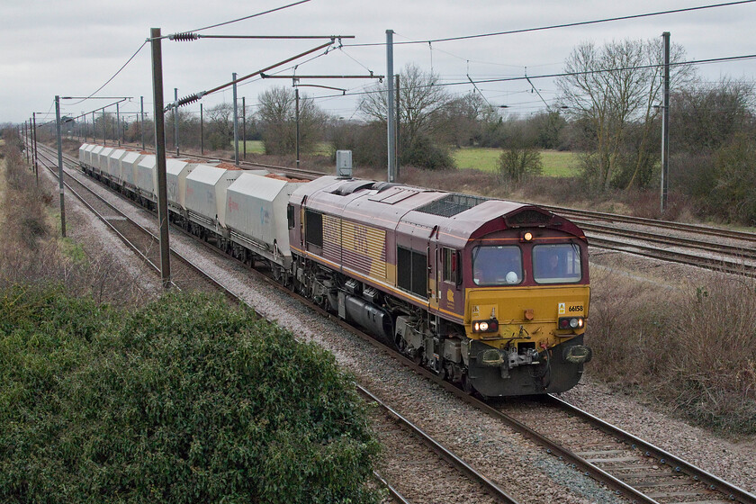 66158, 08.47 Mountsorrel-Barham (6L42, 6E), Marholm TF154036 
 66158 leads the 6L42 08.47 Mountsorrel (Leicestershire) to Barham (near Stowmarket) loaded stone train. It is seen trundling along the up Stamford line at Marholm just north of Peterborough. This is the second EWS liveried and branded Class 66 of the day observed within an hour. 
 Keywords: 66158 08.47 Mountsorrel-Barham 6L42 Marholm TF154036 EWS