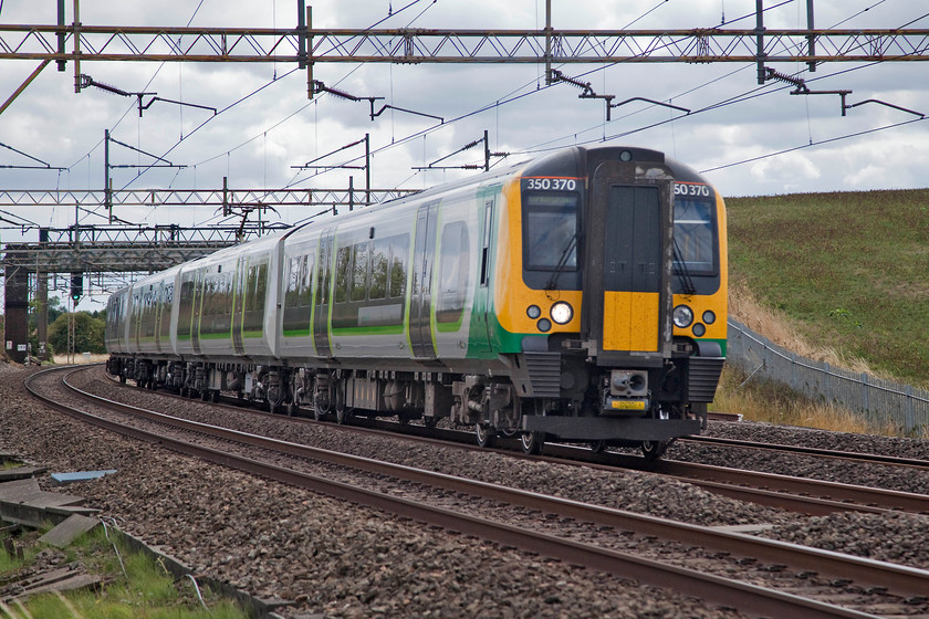 390370, LN 12.13 London Euston-Birmingham New Street (1Y33, RT), Old LInslade 
 Another image that required some Photoshop manipulation to create an acceptable picture. The camera had exposed for the sky meaning that 350370 and much of the foreground was too dark. Luckily, in the darker parts of a digital image there is detail, it just requires judicious use of the levels and shadows functions to lift them out. The Desiro was passing Old Linslade working the 12.13 Euston to Birmingham New Street. 
 Keywords: 390370 1Y33 Old LInslade