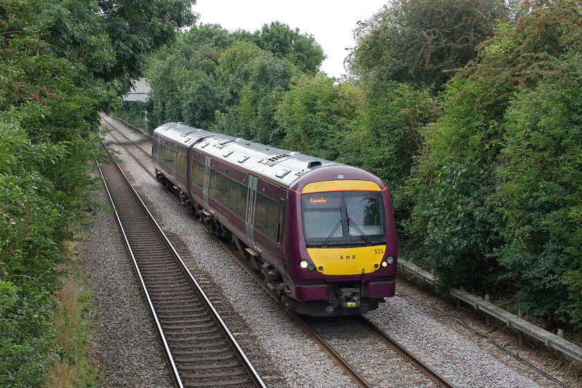 170535, EM 15.11 Peterborough Lincoln Central (2K20, 1E), Helpringham TF137402 
 Taken from a particularly rickety footbridge in the village of Helpringham the EMR 15.11 Peterborough to Lincoln service passes worked by 170535. I find it a strange anachronism that the railways still refer to Lincoln Central Station as it has only had one station since St. Marks was closed nearly forty years ago by BR in May 1985! 
 Keywords: 170535 15.11 Peterborough Lincoln Central 2K20 Helpringham TF137402 EMR East Midlands Railway Turbo