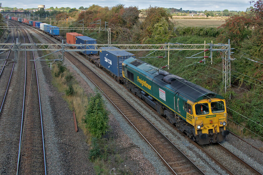 66564, 09.31 Crewe Basford Hall-Southampton MCT (4O35, 12E), Victoria bridge 
 Another example of an 'almost' photograph with the sun illuminating the fields in the background but with the subject in the shade! 66564 leads Freightliner's 4O35 09.31 Crewe Basford Hall to Southampton service. Notice that this Class 66 still wears the large recruitment poster stuck to its flank that it has worn since at least the summer of 2018 so one wonders if getting staff to work for Freightliner is still a problem. 
 Keywords: 66564 09.31 Crewe Basford Hall-Southampton MCT 4O35 Victoria bridge Freightliner