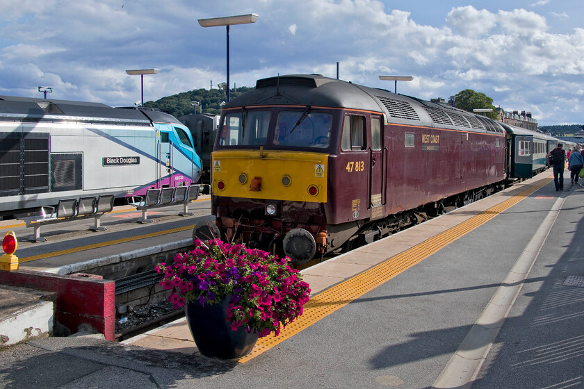 47813, the return leg of The Coronation Deltic, 17.10 Scarborough-London King's Cross (terminated at Finsbury Park) (17.10 Scarborough-Peterborough) (1Z56, 71L) & 68030, stabled, Scarborough station 
 In the afternoon sunshine at Scarborough station the rear of the returning Coronation Deltic charter is seen with West Coast's 47813 waiting to be dragged back south to King's Cross. To its left 68030 'Black Douglas' is stabled (as it had been for the whole day) with a set of the doomed Nova 3 stock. 
 Keywords: 47813 The Coronation Deltic 17.10 Scarborough-London King's Cross 1Z56 68030 Scarborough station Black Douglas