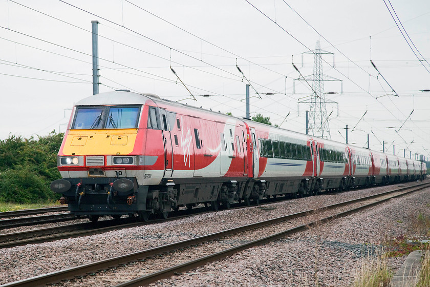 82210, GR 06.00 Berwick-upon-Tweed-London Kings Cross (1Y14, 1L), Tempsford Crossing 
 The 06.00 Berwick-upon-Tweed to London King's Cross has less than 50 miles to go out its 335 mile journey as it passes Tempsford level crossing. It is being led by DVT 82210. 
 Keywords: 82210 1Y14 Tempsford Crossing