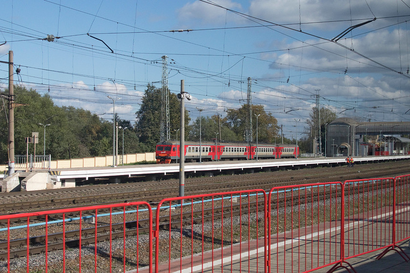 ZT2M-122, unidentified working, Bologoye station 
 Four-car ZT2M-122 stands at the far side of Bologoye station as we arrive on our Sapsan service to Moscow. The red barriers in the foreground separate our arrival platform from the rest of the station. RZD staff deal with passengers both alighting and embarking on the hi-speed Sapsan trains separately with all their details carefully scrutinised before being permitted on-board. 
 Keywords: ZT2M-122 Bologoye station