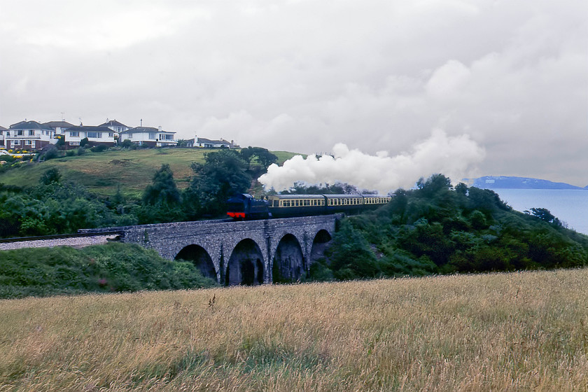 4588, 14.15 Paignton-Kingswear, Hookhills Viaduct SX895577 
 The Collett designed 4575 class of 2-6-2T tanks were a development of the original Churchward 4500 class. One hundred were constructed between 1927 and 1929 as a mixed traffic locomotive and were found all over the GWR network. 4588 was based for most of its working life in Devon and Cornwall until withdrawal came in 1962 at Laira from where it was sent to Barry. After spending nine years deteriorating in South Wales, it was rescued and restored at Swindon works. It is seen here, in awful lighting, climbing towards Churston about to cross Hookhills viaduct working the 14.15 Paignton to Kingswear service on the South Devon Railway. 
 Keywords: 4588 14.15 Paignton-Kingswear Hookhills viaduct SX895577