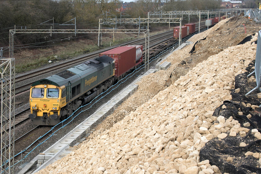 66526, 08.25 Crewe Basford Hall-Felixstowe North (4L93, 50E), Ashton Road bridge 
 66526 'Driver Steve Dunn (George)' leads the 08.25 Crewe Basford Hall to Felixstowe Freightliner service past the almost completed bank reinforcement work at Ashton Road bridge just south of Roade. Whilst the work has opened up the view from this bridge it will be of limited use due to the line running south-east at this location meaning if the sun is out for any time much beyond mid-morning it will be on the wrong side! 
 Keywords: 66526 08.25 Crewe Basford Hall-Felixstowe North 4L93 Ashton Road bridge Driver Steve Dunn (George)