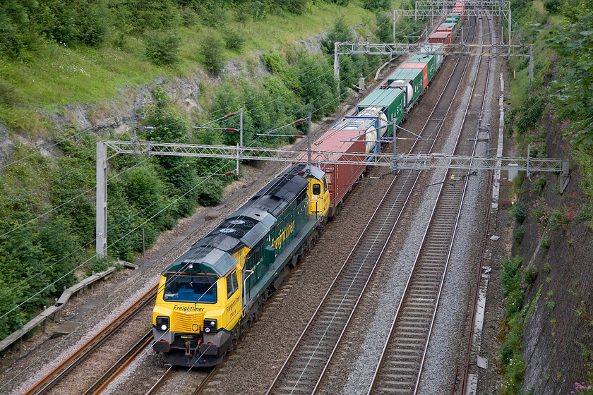 70014, 15.12 Ipswich-Crewe Basford Hall (4M41), Roade Cutting 
 I have commented on the design of the Class 70s before but even from this elevated angle, I think that they remain one of the ugliest locomotives on the network! Freightliner's 70014 leads the 15.12 Ipswich (originating at Felixstowe) to Crewe Basford Hall service noisily through Roade cutting. 
 Keywords: 70014 15.12 Ipswich-Crewe Basford Hall 4M41 Roade Cutting Freightliner