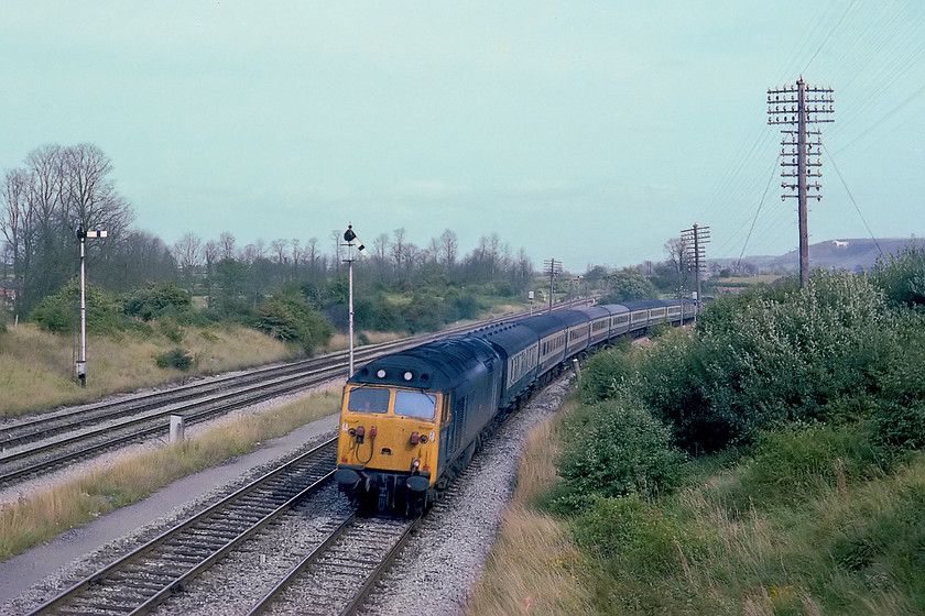 50013, 13.30 London Paddington-Penzance (1B32), Fairwood Junction 
 50013 Agincourt sweeps around the curve as it comes off the Westbury cut-off at Fairwood Junction with the famous white horse on the escarpment in the background. It is leading the 1B32 13.30 Paddington to Penzance that did not stop at Westbury station the lines to and from are on the left. Notice that all the single arm home signal posts in this image are all on the wrong side of the track they control due to various sighting issues. 
 Keywords: 50013 13.30 London Paddington-Penzance 1B32 Fairwood Junction