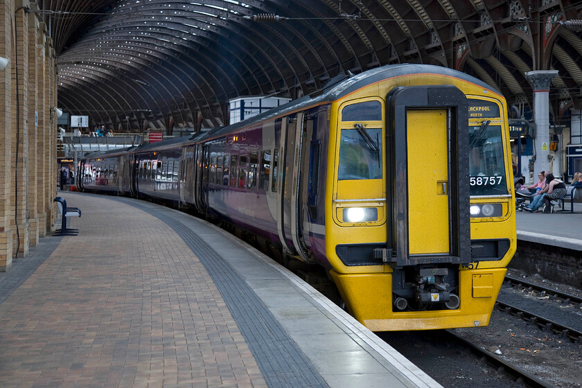 158757, NT 17.18 York-Blackpool North (1B32), York station 
 158757 waits at one of York's busy south-facing bay platforms prior to working the 17.18 to Blackpool North. This Express Sprinter will take an interesting and somewhat convoluted route to the north-west coast resort taking in Leeds, Manchester and Preston on the way. 
 Keywords: 158757 17.18 York-Blackpool North 1B32 York station Northern Trains Express Sprinter