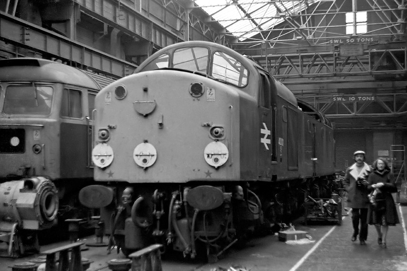 47182 & 40011, Crewe Works 
 Undergoing attention in one of Crewe's repair shops, 47182 and 40011 are seen. 47182 was a local steam-heat engine at the time being based at Crewe Dessel. It moved to Bescot in 1982 and then returned to the works for conversion to ETH in 1983 emerging as 47598. 40011 was approaching the end of a four-month stay at the works having what is described as 'camshaft repairs'. I am not at all sure why camshaft repairs took quite this long; I suspect that there may well have been a lot of other work completed too. 40011 only had another eighteen months in-service being withdrawn from traffic at Healey Mills, later removed to and cut up at Swindon. I managed to see it just six weeks prior to its withdrawal on the Settle and Carlisle, see.... https://www.ontheupfast.com/p/21936chg/29725530004/x4-40-011-down-freight-ais-gill-sd773979 
 Keywords: 47182 40011 Crewe Works