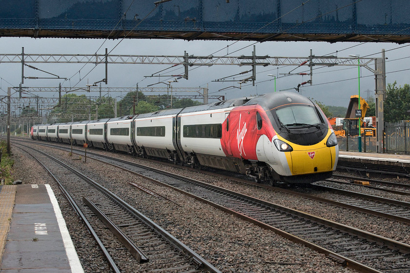 390005, VT 15.02 Blackpool North-London Euston (1A93, 5L), Rugeley Trent Valley station 
 390005 'City of Wolverhampton' passes Rugeley Trent Valley in dramatic lighting forming the 15.02 Blackpool North to London Euston. To date, this is my first photograph of a Virgin Blackpool service. The black sky behind the train was to deliver yet more rain after a brief respite when the sun actually put in an all too brief appearance. 
 Keywords: 390005 15.02 Blackpool North-London Euston 1A93 Rugeley Trent Valley station