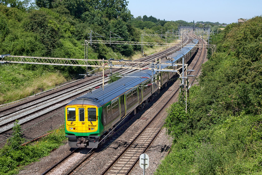 319441, LN 11.16 Bletchley CS-Northampton EMD ECS (5N99), Victoria Bridge 
 I only ever seem to photograph the small number of class 319s that London Northwestern operates when running as empty coaching stock! I believe that I have only ever taken a picture of a service train on one occasion? Here, 319441 (and one of its classmates) forms the 11.16 Bletchley CS to Northampton EMD 5N99 working. It is passing Victoria Bridge near to Roade on the southern WCML. 
 Keywords: 319441 5N99 Victoria Bridge