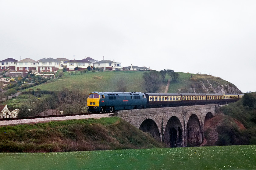 D1013, 14.30 Paignton-Kingswear, Broadsands Viaduct SX893574 
 D1013 'Western Ranger' works hard on the gradient from virtually sea-level at Goodrington to this point where it crosses Broadsands Viaduct just before Churston. It was a shame that it was such a dull day for our visit to Devon to see the two resident Westerns in action on what was to be their final day in service on the line. 
 Keywords: D1013 14.30 Paignton-Kingswear Broadsands Viaduct SX893574