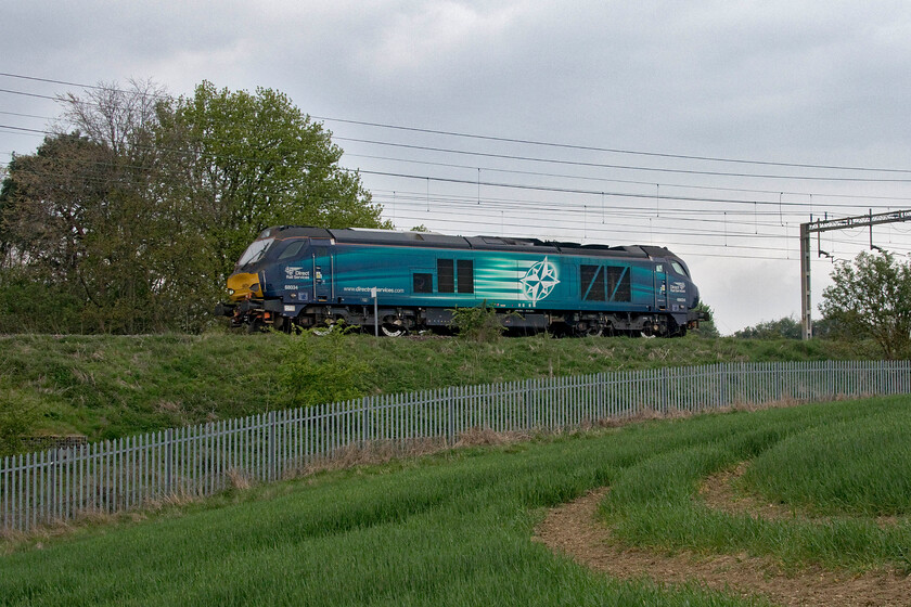 68034, 10.20 Crewe Gresty Bridge-Wolverton Works (16E), between Roade & Ashton 
 In association with one of the many stock moves to and from Wolverton Works DRS' 68034 heads south between Roade and Ashton. The Class 68 left Gresty Bridge at 10.20 but despite various searches, I could find no reporting number. 
 Keywords: 68034 10.20 Crewe Gresty Bridge-Wolverton Works between Roade & Ashton DRS Direct Rail Services