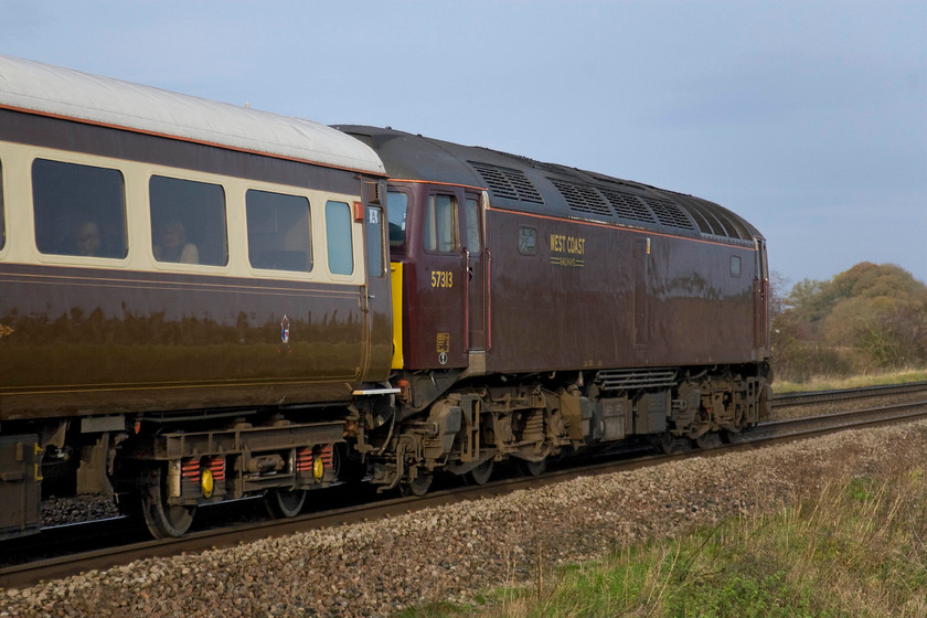 57313, outward leg of The Bath Christmas Statesman, 04.12 Aberystwyth-Bath (1Z82), King's Sutton 
 Dead in tow on the rear of Statesman Rail's 1Z82 charter 57313 is seen passing King's Sutton. This locomotive led the train earlier in the day when it left Aberystwyth at an anti-social 04.12 being piloted by ERTMS equipped 97301 (ex 37182). This photograph shows one of Statesman Rail's Mk.IIf coaches that look smart in their part Pullman, part GWR style livery. 
 Keywords: 57313 The Bath Christmas Statesman, 04.12 Aberystwyth-Bath 1Z82 King's Sutton West Coast Railways Statesman Rail