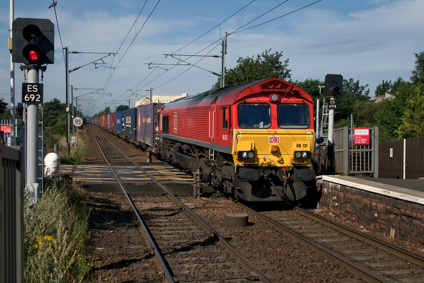 66131, 07.05 Mossend-Tees Dock (4E96), Kingsknowe station 
 66131 crosses the Kingsknowe Road level crossing at the station of the same name. It is leading the 07.05 Mossend to Tees Dock 4E96 Freightliner. This service will soon take the Edinburgh avoiding line at the nearby Slateford Junction and rejoin the ECML at Monktonhall Junction near Musselburgh. 
 Keywords: 66131 07.05 Mossend-Tees Dock 4E96 Kingsknowe station