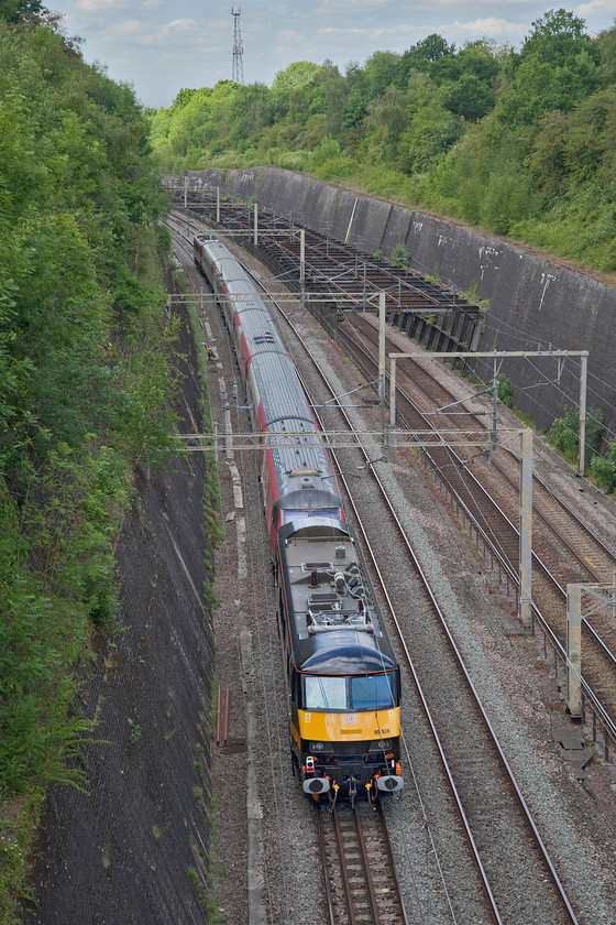 90026, 82201 & 90037, 13.32 Wembley Inter City depot-Widnes Transport Technical Centre (5Z90, 4E), Roade cutting 
 Dead in tow the smartly repainted 90037 is at the rear of the 13.32 Wembley to Alstom (Widnes) 5Z90 special working. Along with a short set of former LNER liveried Mk.IVs (12211, 12434, 12310, 11319 and 82201) the convoy is seen taking the Weedon route towards Rugby through Roade cutting with 90037 providing the power at the front. The set of stock and the GC liveried and branded Class 90 were being taken to the Widnes facility for secure storage awaiting developments following Grand Central's complete shutdown during the pandemic period. It is not at all certain if it will commence operations again and, if it does, whether its plans to operate its new services, that this stock was to be utilised on, will come to fruition. 
 Keywords: 90026 82201 90037 13.32 Wembley Inter City depot-Widnes Transport Technical Centre 5Z90, Roade cutting LNER GC Grand Central