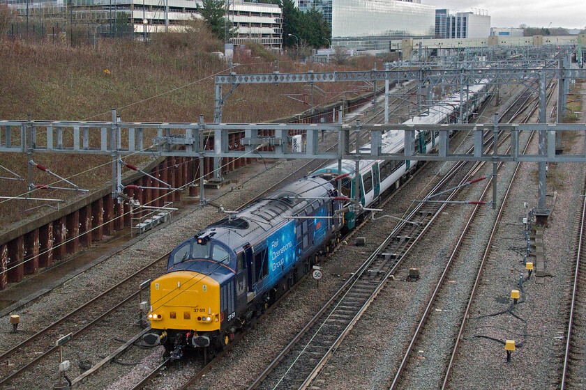 37611 & 730203, 11.58 Wembley IC Depot-Old Dalby (5Q58, 8L), Loughton Redway bridge, Milton Keynes 
 Having been checked just south of Milton Keynes station 37611 Denise gets up to speed towing a brand new Aventra to be put through its paces on the Old Dalby test track. 730203 will be entering service for London Northwestern on this line once it has been tested and passed for operation, something that should have occurred some time ago now. The train was running as the 11.58 Wembley Yard to Old Dalby with a reporting number of 5Q58. 
 Keywords: 37611 730203 11.58 Wembley IC Depot-Old Dalby 5Q58 Loughton Redway bridge Milton Keynes Denise Wetton