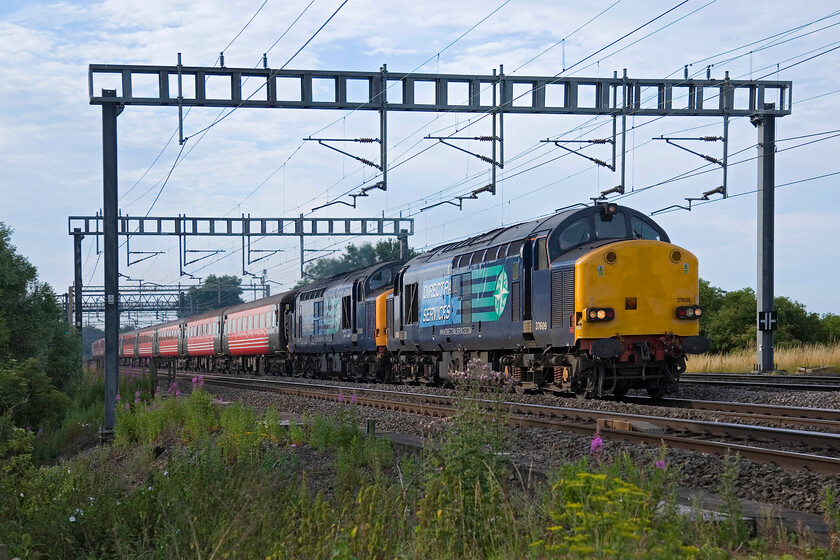 37609 & 37603, outward leg of The Pennine North Eastern Explorer, 07.10 Milton Keynes Central-Durham (1Z83), between Roade & Ashton 
 DRS' 37609 and 37603 make a fine sight as they haul the 1Z83 Pennine North Eastern Explorer charter between Roade and Ashton. The Compass Tours charter had just left its starting point at Milton Keynes and would head via Manchester and a trip across the Pennines to Leeds and onwards to Durham giving passengers an hour or two to explore the city no doubt looking forward to some more English Electric thrash on the return journey! 
 Keywords: 37609 37603 The Pennine North Eastern Explorer, 07.10 Milton Keynes Central-Durham 1Z83 between Roade & Ashton