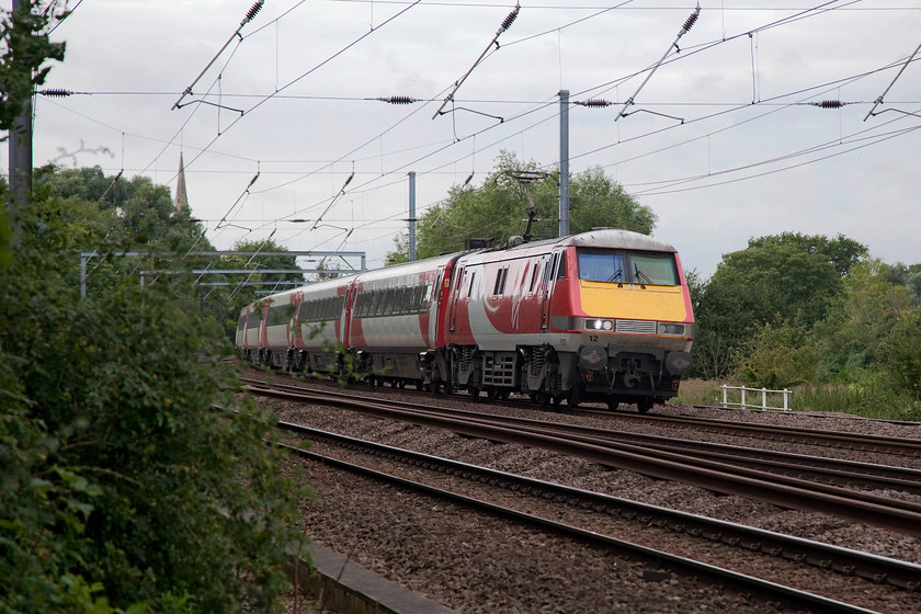 91112, GR 08.35 London Kings Cross-Leeds (1D06, 1E), Gills Crossing 
 Taken from Gill's Crossing in Offord Cluny 91112 heads north through the reverse curves that follow the River Great Ouse with the 08.35 King's Cross to Leeds. In the background can be seen the spire of the Grade I listed Norman church of St. Peter in Offord D'Arcy. 
 Keywords: 91112 1D06 Gills Crossing