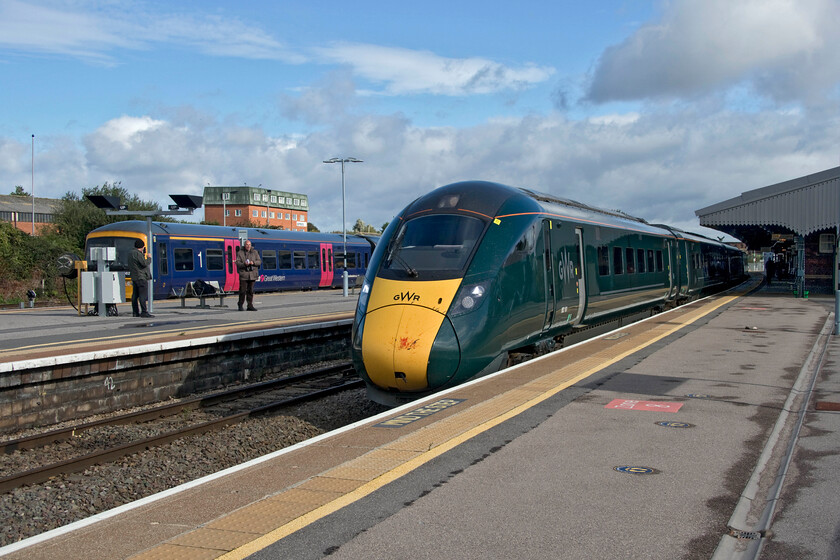 802101, GW 09.37 London Paddington-Paignton (1C75, 12L) & 166201, GW 09.27 Cardiff Central-Portsmouth Harbour (1F11, 4L), Westbury station 
 A busy scene at Westbury station was added to by some of the gathered enthusiasts who always seem to frequent the platforms at this active place in deepest Wiltshire! To the left 166201 is impatiently waiting to leave with the now late-running 09.27 Cardiff Central Portsmouth Harbour service. The reason for its impatience is that it is a connecting service with the 09.37 Paddington to Penzance train that is seen arriving some ten minutes late being worked by 802201. Things did not improve for the 1C75 as it did not make up its lost time arriving at its Devon destination twelve minutes late. It looks as though the leading cab has been in collision with some poor unfortunate creature on its journey from London! 
 Keywords: 802101 09.37 London Paddington-Paignton 1C75 166201 09.27 Cardiff Central-Portsmouth Harbour 1F11 Westbury station Great Western Railway GWR