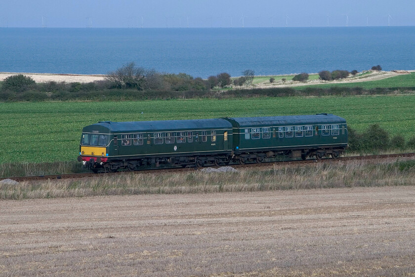 M51192 & M56352, 11.15 Sheringham-Holt, Weybourne Wood TG128424 
 Taken from a footpath that passes below Weybourne Wood the 11.15 Sheringham to Holt DMU service is seen climbing towards the station. The service is being worked by one of the resident Class 101 DMUs formed by M51192 and M56352. It was a glorious autumn day making a walk along the coast with my family with the added bonus of passing trains an absolute pleasure; it was a shame that it was the last day of our break! 
 Keywords: M51192 M56352 11.15 Sheringham-Holt Weybourne Wood TG128424 Class 101 First generation DMU