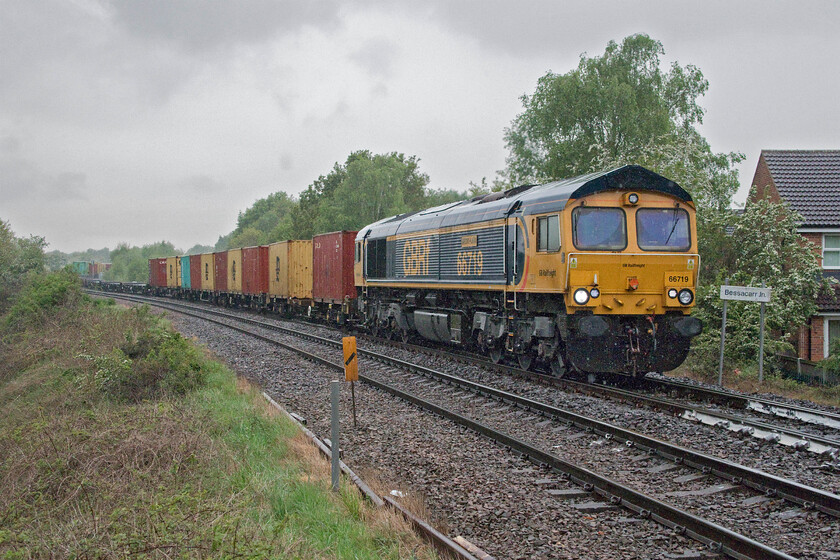 66719, 11.38 Masborough-Felixstowe North (4L11, 5E), Bessacarr Junction 
 The things that we do in pursuit of our hobby! In absolutely torrential rain GBRf's 66719 'Metro-Land' leads the 4L11 11.38 Masborough to Felixstowe North Freightliner past Bessacarr Junction. The train is just descending from the flyover that avoids it having to physically interfere with the busy ECML just south of Doncaster. It is about to join the former Great Northern & Great Eastern Joint Railway route to Lincoln via Gainsborough. It will then take the Great Northern route back to the ECML again at Peterborough via Spalding. 
 Keywords: 66719 11.38 Masborough-Felixstowe North 4L11 Bessacarr Junction Metro-Land GBRf Freightliner