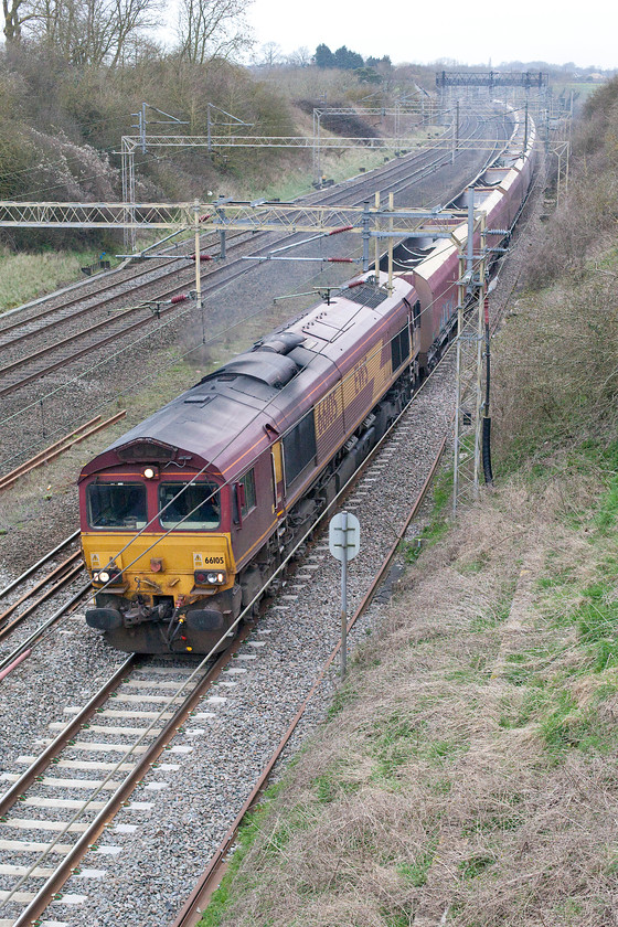 66105, 02.19 Peak Forest-Bletchley, Victoria bridge 
 66105 leads the 02.19 Peak Forest to Bletchley ballast train past Victoria Bridge just south of Roade on the WCML. It is not common to see this working on this route, it usually travels via the MML crossing to Bletchley via the Marston Vale line from Bedford. 
 Keywords: 66105 02.19 Peak Forest-Bletchley Victoria bridge