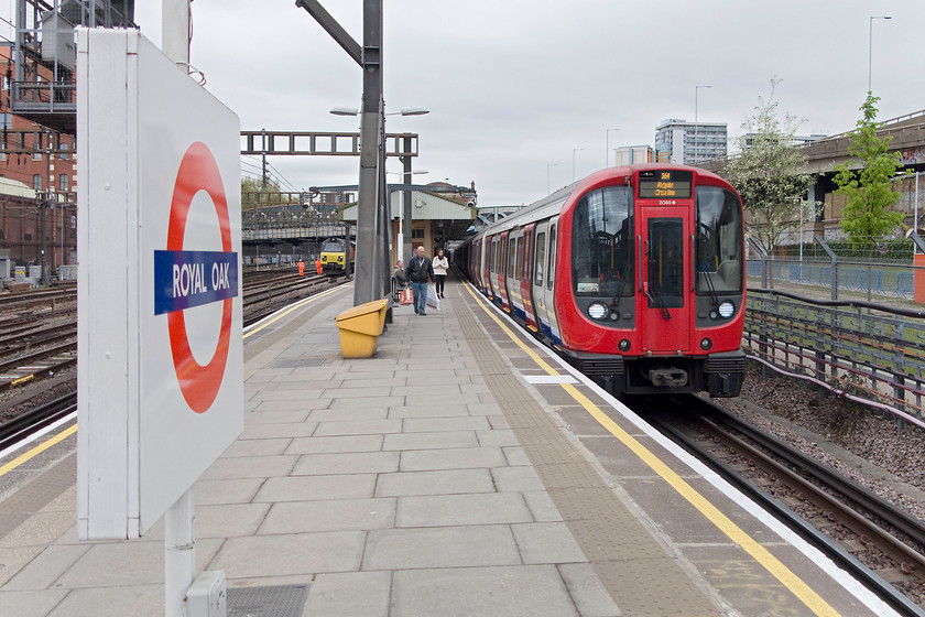 21360, Circle Line Aldgate working & 70807, stabled, Royal Oak LU station 
 S7 stock number 21360 arrives at Royal Oak station with a Circle Line service to Aldgate. I took this train as far King's Cross and St. Pancras for the second session of the afternoon. Notice 70807 stabled on the adjacent NR line. 
 Keywords: 21360 70807 Royal Oak LU station