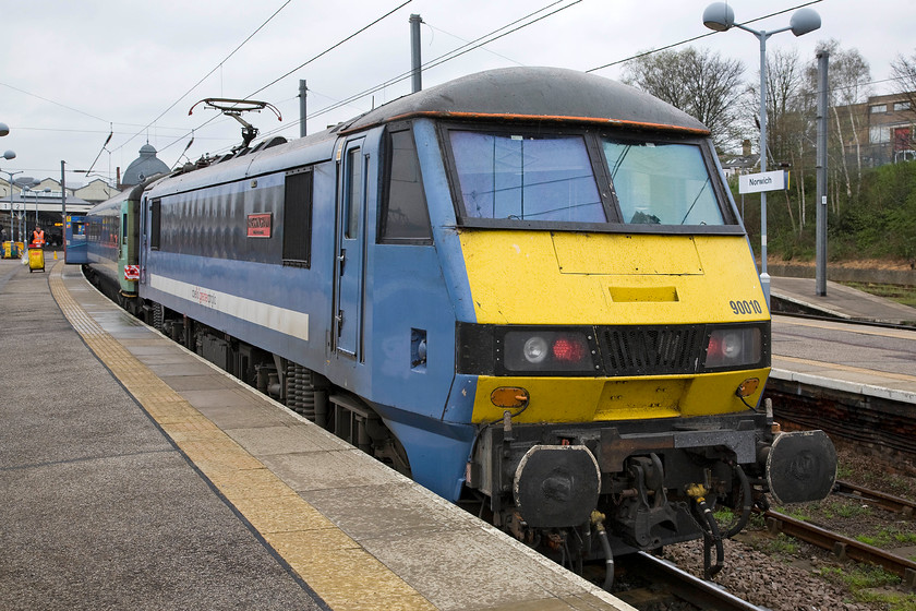 90010, LE 16.00 Norwich-London Liverpool Street (1P51), Norwich station 
 90010 'Bressingham Steam & Gardens' waits at Norwich whilst its stock is cleaned and prepared. It will then work the 16.00 departure to London Liverpool Street. I saw and photographed the same locomotive four and a half hours earlier, see.... https://www.ontheupfast.com/p/21936chg/29952518404/x90010-11-00-norwich-london-liverpool in the same place on the same platform. In the intervening time, the locomotive and stock have worked to London and back. 
 Keywords: Bressingham Steam & Gardens 90010 16.00 Norwich-London Liverpool Street 1P51 Norwich station Greater Anglia