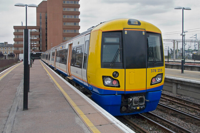 378233, LO 13.21 Watford Junction-London Euston (13.21 Watford Junction-Willesden Junction (2C26), Watford Junction station 
 As it was clear that my London Midland train to Euston was going to struggle to make it to its destination with warnings from the guard over the public address stating that it was going to be terminated before reaching its destination I opted, along with a number of other passengers, to hop off at Watford Junction. With ticket restrictions now waved I took 378233 working London Overgrounds 13.21 service to Euston that itself was terminated at Willesden Junction where I was going to alight to change anyway. The train is here waiting to leave Watford Junction but has yet to have its marker lights illuminated by the driver. 
 Keywords: 378233 13.21 Watford Junction-London Euston 2C26 Watford Junction station London Overground