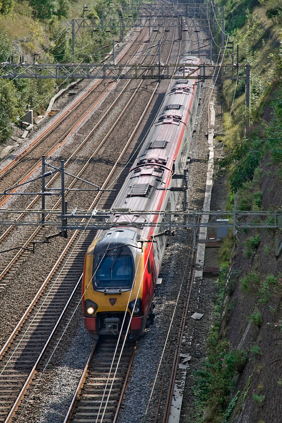 Class 221, VT 12.43 London Euston-Edinburgh Waverley (9S70), Roade cutting 
 An unidentified Class 221 Voyager passes through Roade cutting working the 12.43 Euston to Edinburgh Virgin service. A single set five coach DMU (even if it can do one hundred and twenty-five miles per hour) all the way to Edinburgh from London under 25Kv wires......come on! 
 Keywords: Class 221 12.43 London Euston-Edinburgh Waverley 9S70 Roade cutting Virgin Trains West Coast Voayger