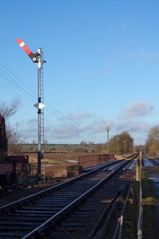 Signal & bridge 13 
 In the New Year's Day sunshine, Pitsford's down starter is pulled off ready for the next round trip working. Also in this view is Bridge 13. This was major headache to the preserved line some years ago as it required a complete and very expensive re-build. 
 Keywords: Pitsford and Brampton Bridge 13 home signal