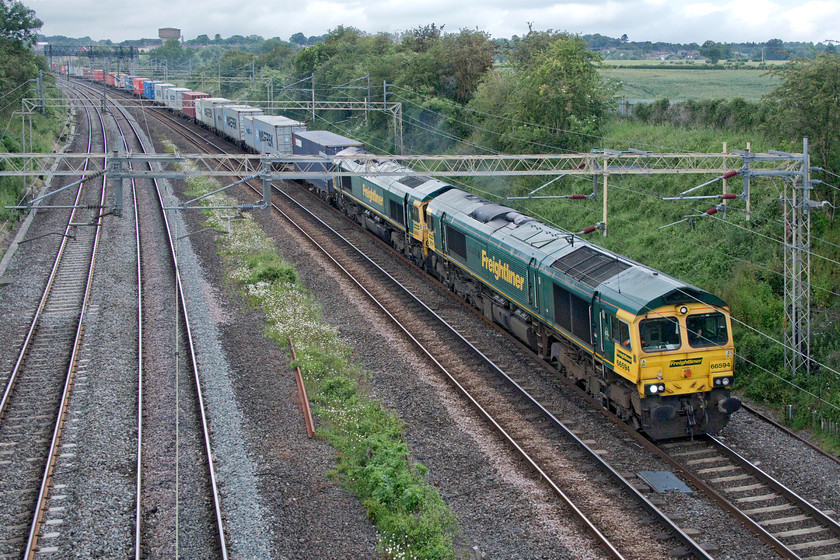 66594 & 66553, 10.15 Trafford Park-Felixstowe North (4L90, 20E), Victoria bridge 
 66594 'NYK Spirit of Kyoto' will have its work cut out hauling the 10.15 Trafford Park to Felixstowe as not only is the train fairly lengthy and well-laden but 66553 is dead in tow. The train left Manchester over thirty minutes late but by the time it passed me here at Victoria bridge just south of Roade it was on time but this was courtesy of missing out a layover at Crewe Basford Hall eventually arriving at Felixstowe twenty minutes early. 
 Keywords: 66594 66553 10.15 Trafford Park-Felixstowe North Victoria bridge Freightliner NYK Spirit of Kyoto 4L90