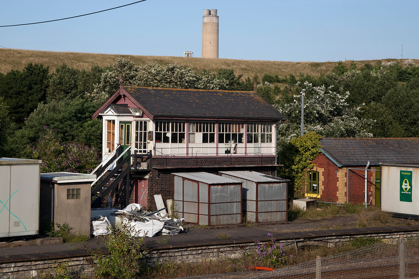 Aberthaw signal box (Barry, 1897) 
 Aberthaw signal box sits on the platform of the former Aberthaw Low Level station that closed 05.05.30. The box is a Barry Railway structure that dates from 1897. It contains an NX panel and a 53-lever frame. The box remains purely because it controls entry and exit to Aberthaw power station that can be seen emerging from the bank behind. It is now Grade II listed so its future after closure is assured in some form or another. 
 Keywords: Aberthaw signal box