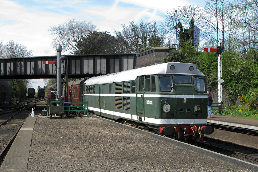 D5631, 12.45 Holt-Sheringham, Sheringham station 
 The sun may be out but there was a brisk wind blowing and it was a chilly day typical of what can be experienced at the start of April. The 12.45 Holt to Sheringham North Norfolk Railway service arrives at its destination with D5631 leading. Despite having undergone a relatively recent restoration the paintwork on the former 31207 is already looking somewhat faded. When it was restored the as-built cab end interconnecting doors on this end were not reinstated with the plates fitted by BR still in place. In addition, the later headcode marker lights were retained rather than reinstating the original alphanumeric type that would have been fitted when the loco. was in this livery. 
 Keywords: D5631 12.45 Holt-Sheringham Sheringham station NNR North Norfolk Railway Poppy Line 31207