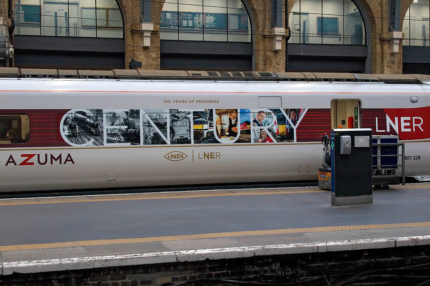 Graphics, 801228, GR 08.03 London King's Cross-Leeds (1D05, 8L), London King's Cross station 
 An interesting graphic applied to the side of Azuma 801228 photographed inside King's Cross station. The LNER came about due to grouping and became one of the 'big four' on 01.01.23. In a nod to its heritage, the now state-owned LNER chose to celebrate this centenary at the start of this year illustrating key points in its hundred-year history. 
 Keywords: Graphics 801228, GR 08.03 London King's Cross-Leeds 1D05 London King's Cross station LNER Azuma