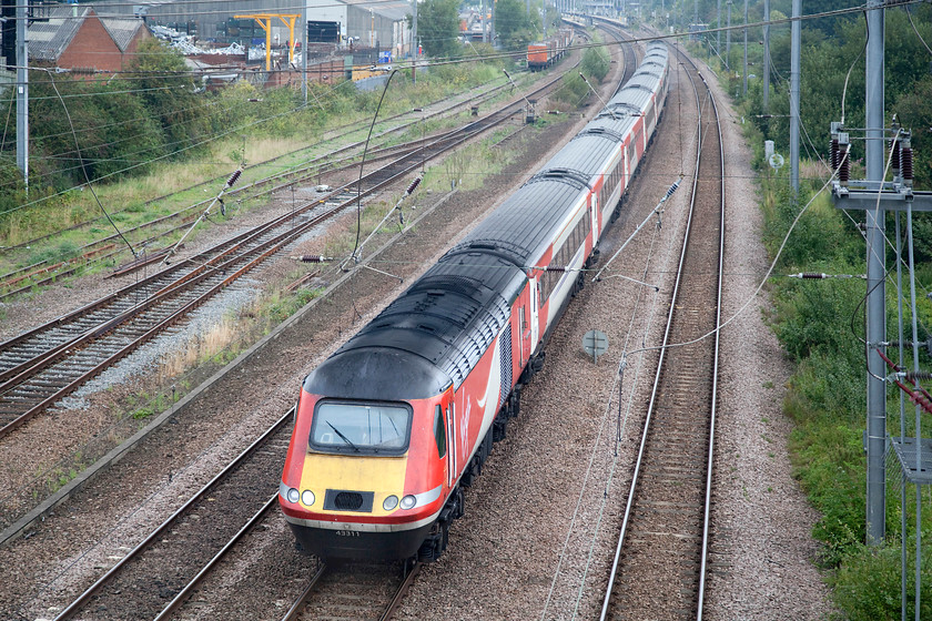 43311,GR 07.34 Harrogate-London Kings Cross (1A15, 3L), Biggleswade Grasmere Road footbridge 
 43311 leads the 07.34 Harrogate to King's Cross through Huntingdon taken from Grasmere Road footbridge. Huntingdon station can just be seen in the background of this picture as can the PW sidings to the left. 
 Keywords: 43311 1A15 Biggleswade Grasmere Road footbridge