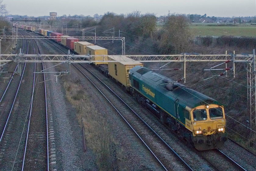 66522, 03.21 Garston-London Gateway (4L52, RT), Victoria bridge 
 In the grey half-light of a January morning 66522 leads the well-loaded 4L52 03.21 Garston to London Gateway Freightliner past Victoria bridge just south of Roade. Whilst the photograph will win no prizes for its technical quality, it makes up for this for its atmospherics; well, I think so anyway! 
 Keywords: 66522 03.21 Garston-London Gateway 4L52 Victoria bridge