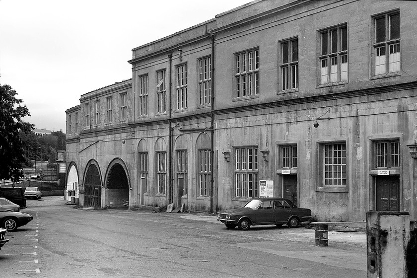 Rear of down side, Bath Spa station 
 The rear of Bath Spa station from the down side looks a little run-down. The car park is virtually empty apart from a rare Singer Vogue (based on a lowly Hillman Hunter), a BMW 6 series, a Porsche 928, an Austin Maxi and at the bottom, past the Leyland Sherpa is a Daf 33. The rear of Bath station looks very similar today, but has been tidied up somewhat and the car park is a lot more full! 
 Keywords: Rear of down side Bath Spa station