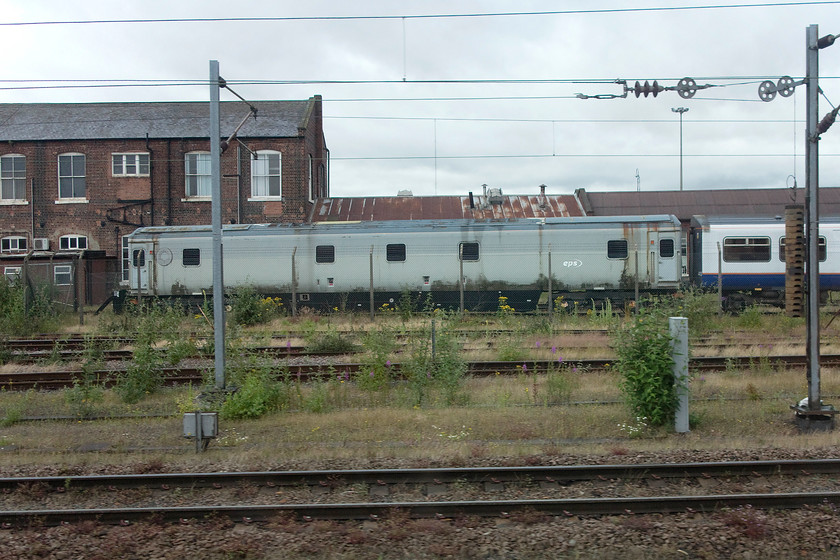 96374 (Nightstar generator coach), Doncaster yard 
 At Doncaster, one of the few remaining pieces of Nightstar stock that did not get sold to Canada is seen. Interestingly, 96374 is classified as a locomotive even though it was actually generator coach. It was designed to be used on the Nightstar services when they were hauled by class 37s as these locomotives did not have enough ETH capability. The 96s were converted Mk.III sleeper coaches of which a number were manufactured; a concept very similar to the ETHELs that were used when the Mk.III sleeper coaches were introduced in Scotland in the early 1980s. 
 Keywords: 96374 Nightstar generator coach Doncaster yard